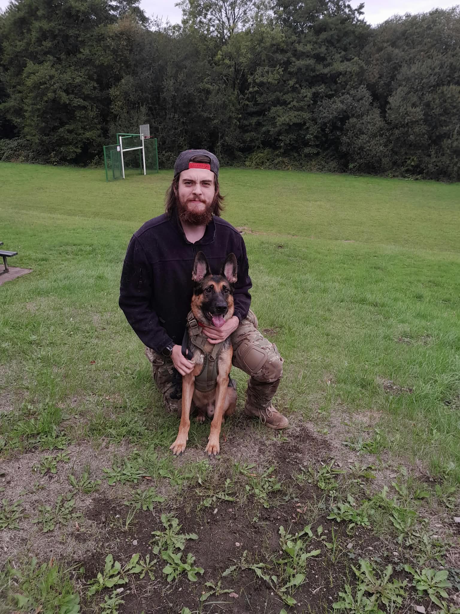 Dylan outdoors with a German Shepherd